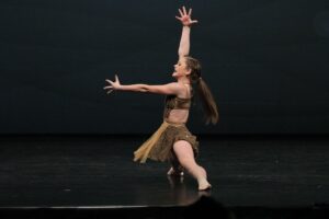 A girl dances on a stage